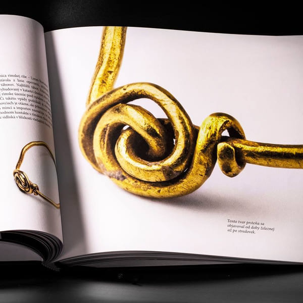 Open book — the Roman-period chapter with a gold ring.